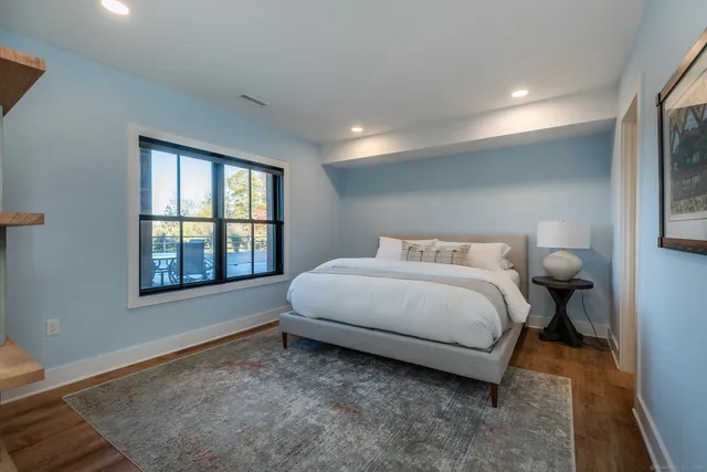 a spacious bedroom with a bed and a window