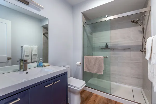 a bathroom with a sink a toilet and shower