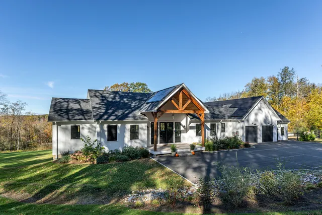a front view of a house with a garden