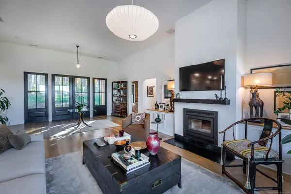 a living room with furniture fireplace and flat screen tv