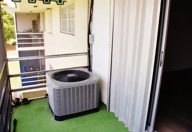a kitchen with a window and wooden floor