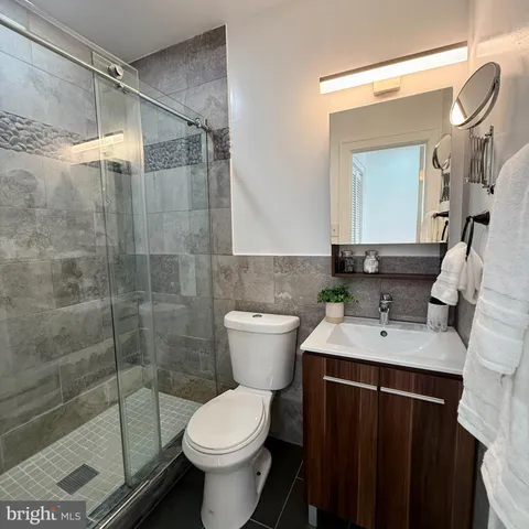 a bathroom with a sink toilet and shower