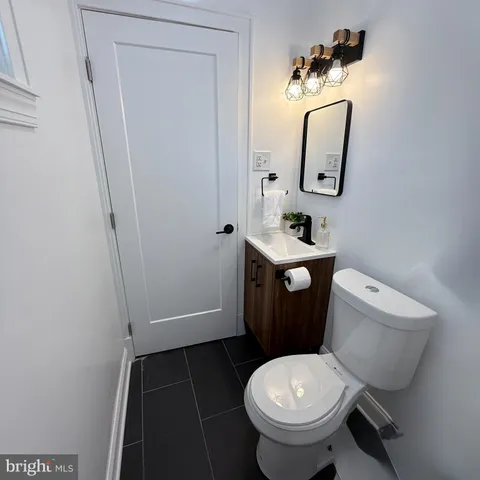 a white toilet sitting next to a bathroom sink