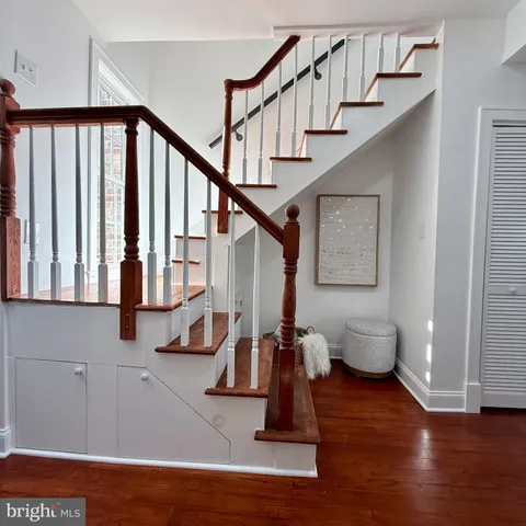 a view of entryway with wooden floor and stairs