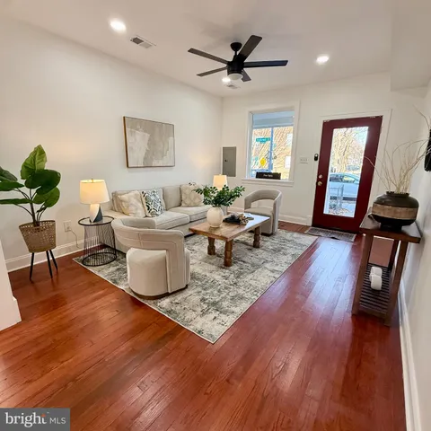a living room with furniture and wooden floor