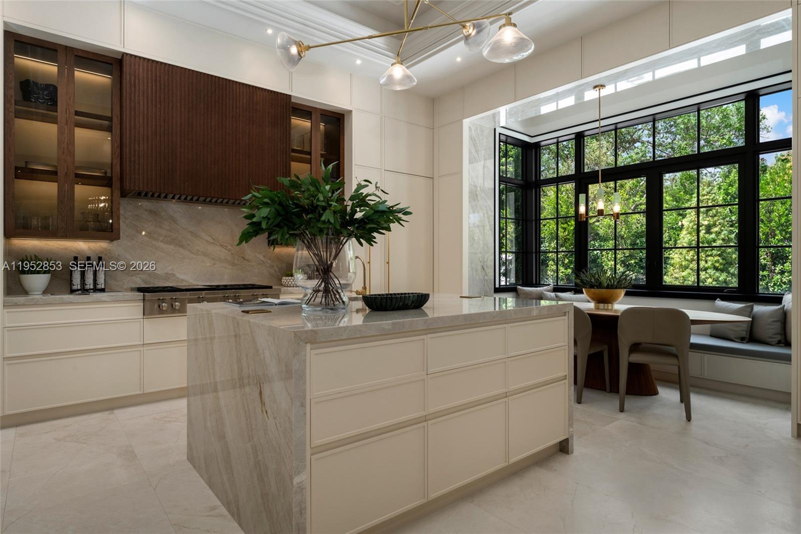 5901 Southwest 107th Street Pinecrest, FL 33156 - Photo 15 of 47 a kitchen with kitchen island a large window in it
