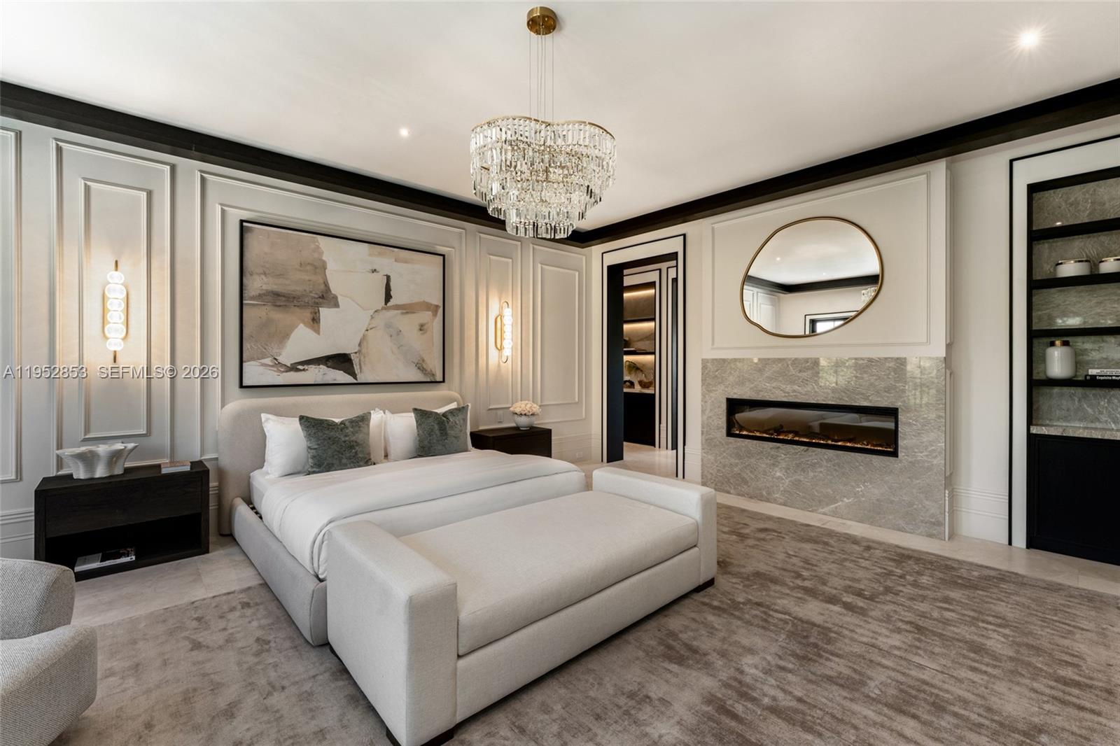 5901 Southwest 107th Street Pinecrest, FL 33156 - Photo 24 of 47 a bedroom with a bed and a chandelier