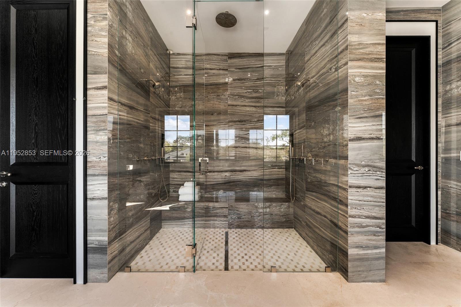 5901 Southwest 107th Street Pinecrest, FL 33156 - Photo 26 of 47 a bathroom with a glass shower door