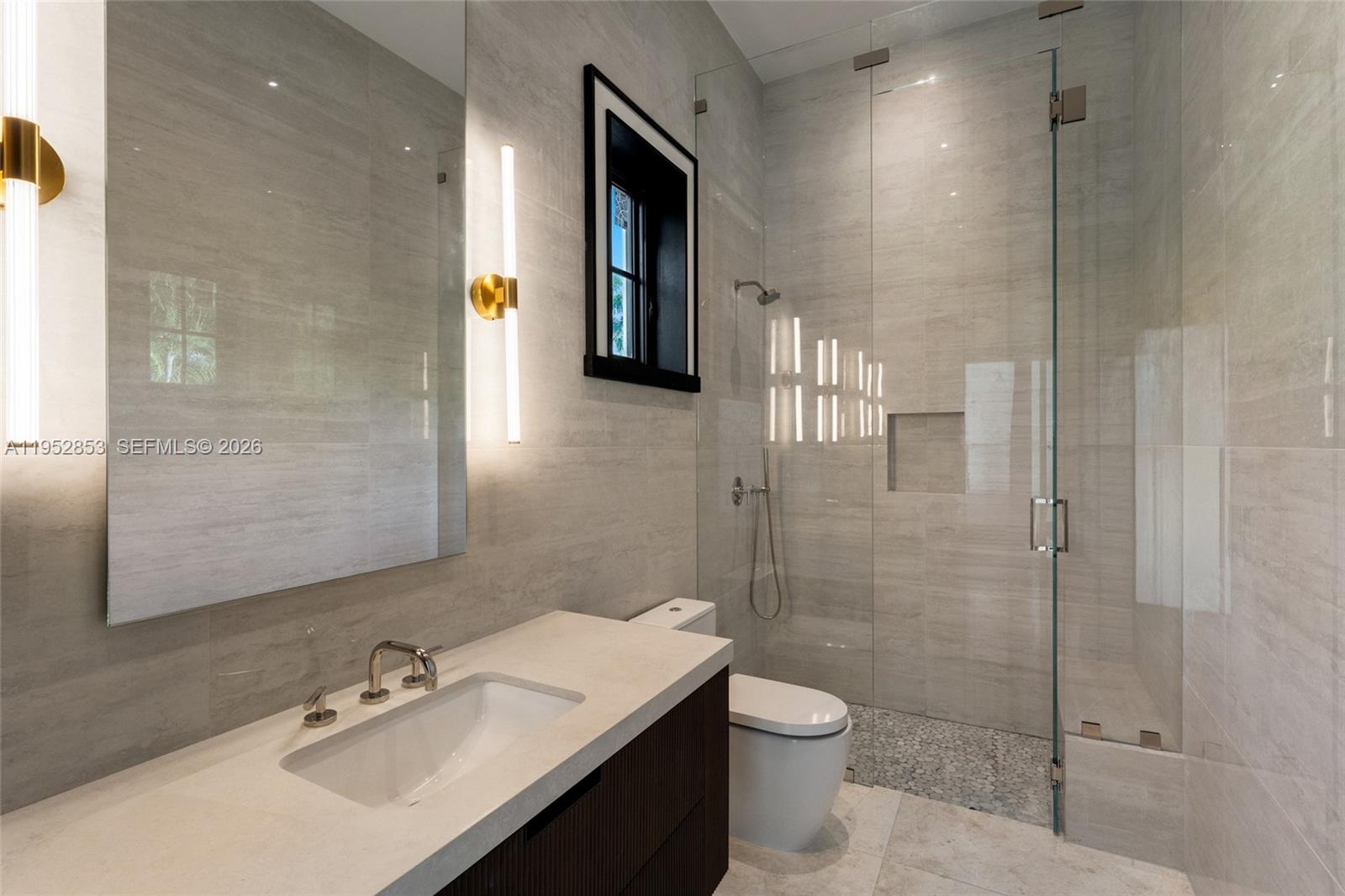 5901 Southwest 107th Street Pinecrest, FL 33156 - Photo 31 of 47 a bathroom with a sink toilet and shower