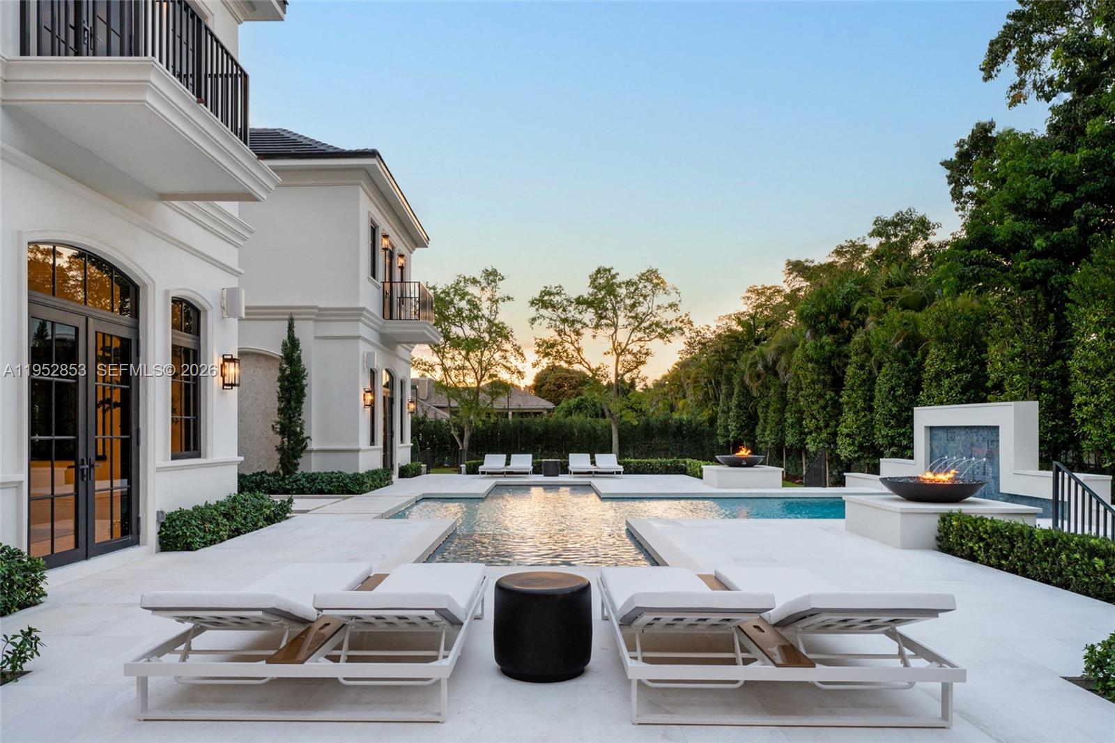 5901 Southwest 107th Street Pinecrest, FL 33156 - Photo 42 of 47 a swimming pool with outdoor seating and yard