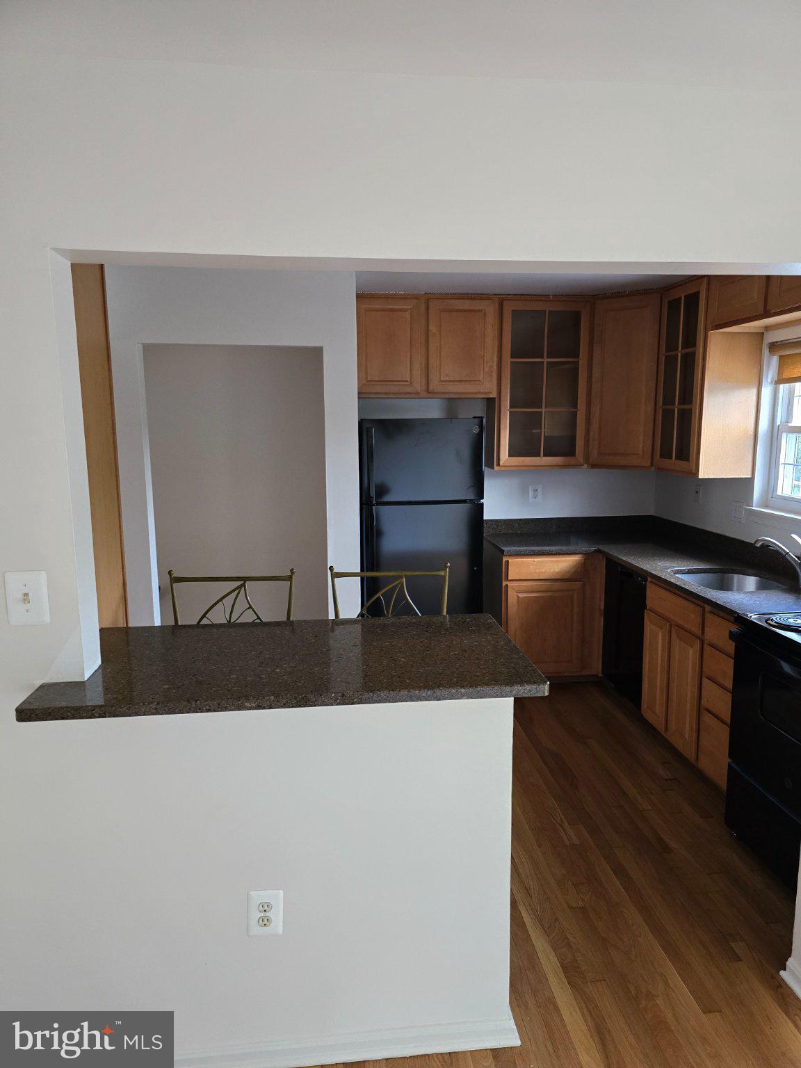 809 St Michaels Drive Bowie, MD 20721 - Photo 4 of 17 a living room with stainless steel appliances kitchen island granite countertop a cabinets and a wooden floor