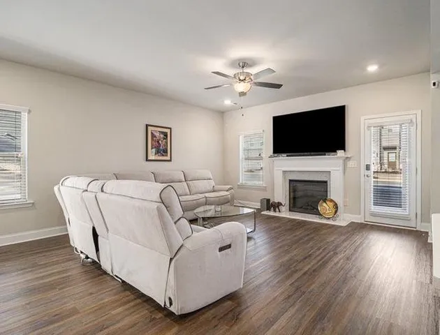 a living room with furniture a fireplace and a flat screen tv