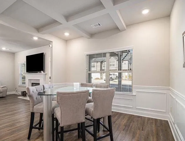 a view of a dining room with furniture wooden floor and a flat screen tv