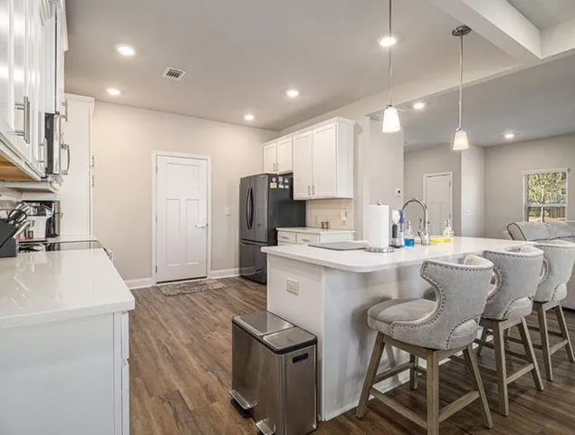 a kitchen with kitchen island a sink stove and refrigerator