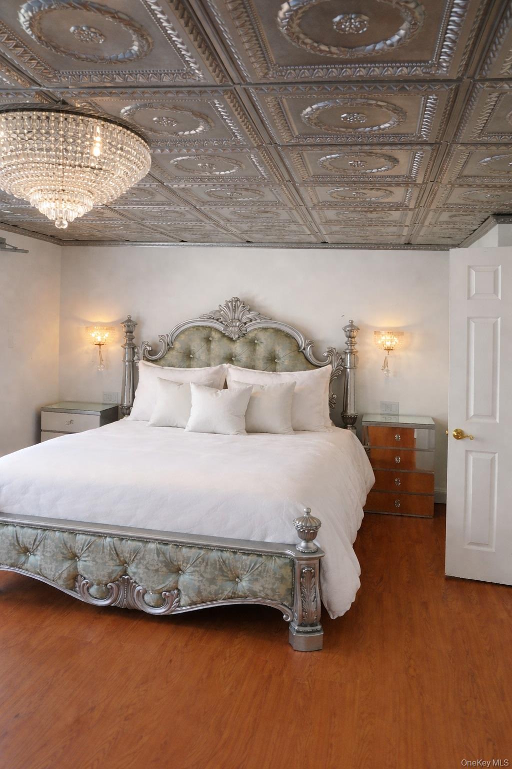 1155 Webster Avenue New Rochelle, NY 10804 - Photo 11 of 35 a bedroom with a bed and a chandelier