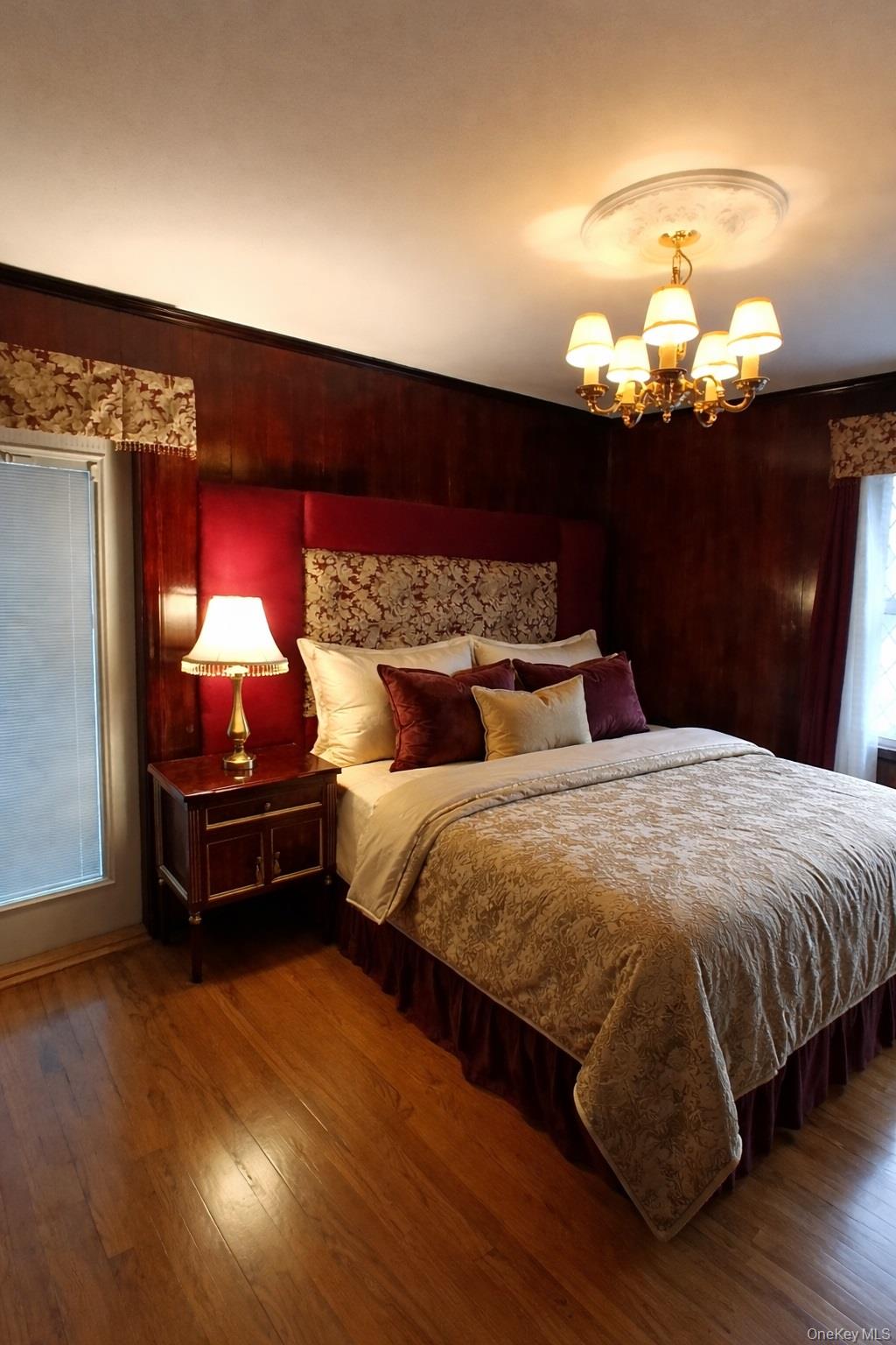 1155 Webster Avenue New Rochelle, NY 10804 - Photo 15 of 35 a bed sitting in a bedroom next to a lamp