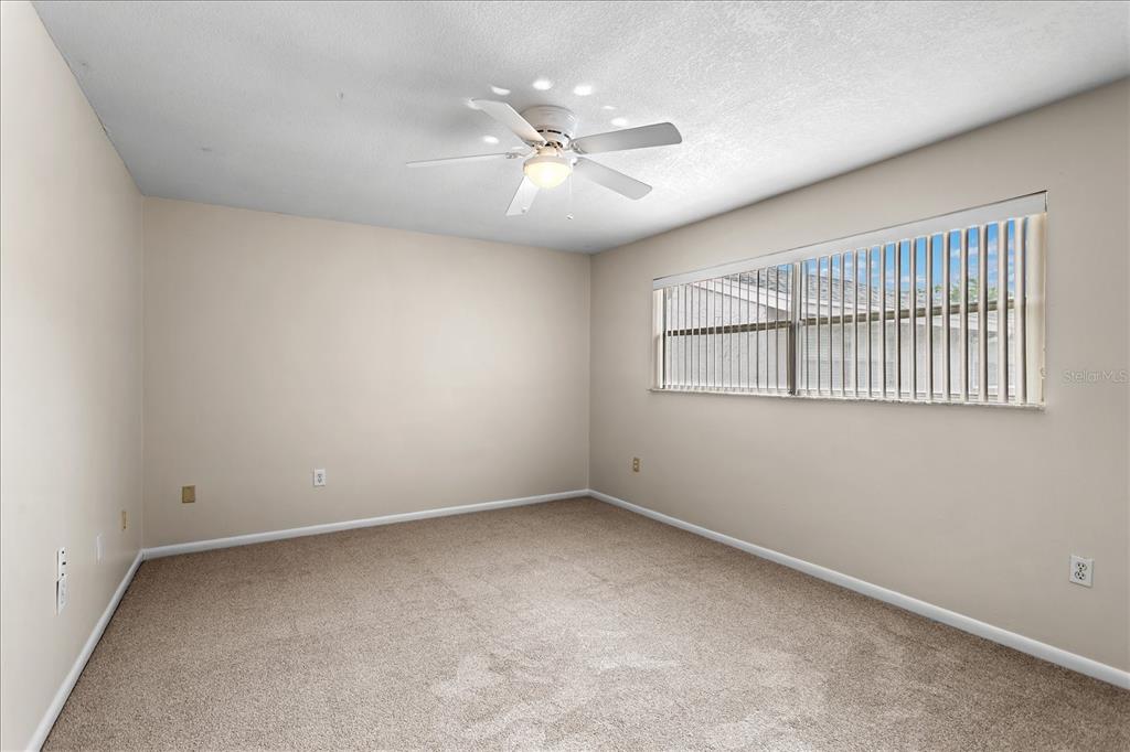 2786 Curry Ford Road, Unit 6B Orlando, FL 32806 - Photo 10 of 27 an empty room with windows and fan