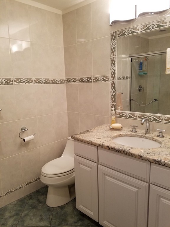 85 Birch Road Longmeadow, MA 01106 - Photo 14 of 26 a bathroom with a granite countertop sink a toilet and a mirror