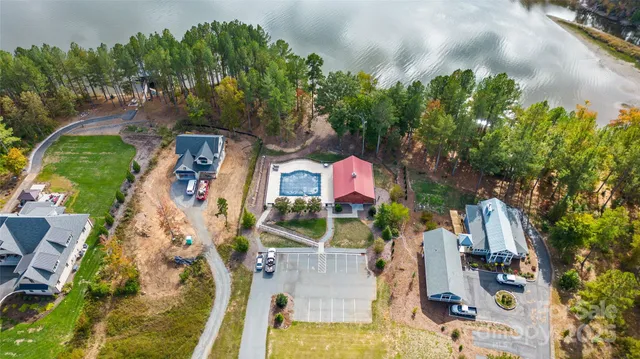 an aerial view of residential house with outdoor space and trees