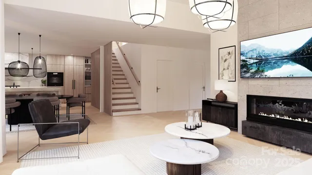 a living room with furniture a fireplace and a large window