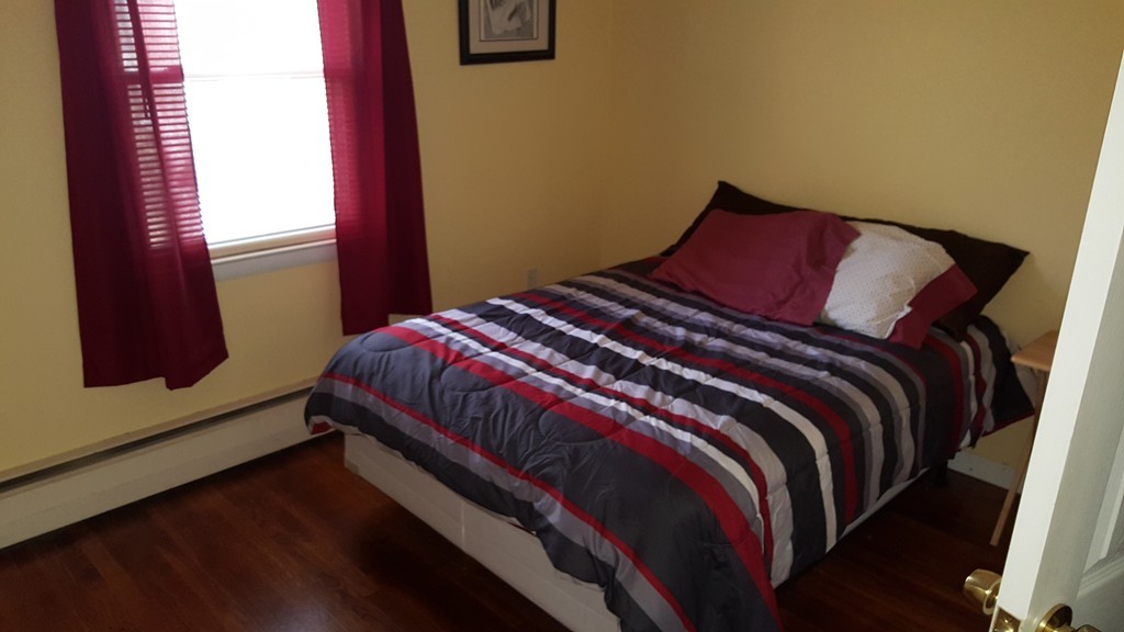 4 Sovereign Heights Sutton, MA 01590 - Photo 12 of 16 a bedroom with a bed and wooden floor