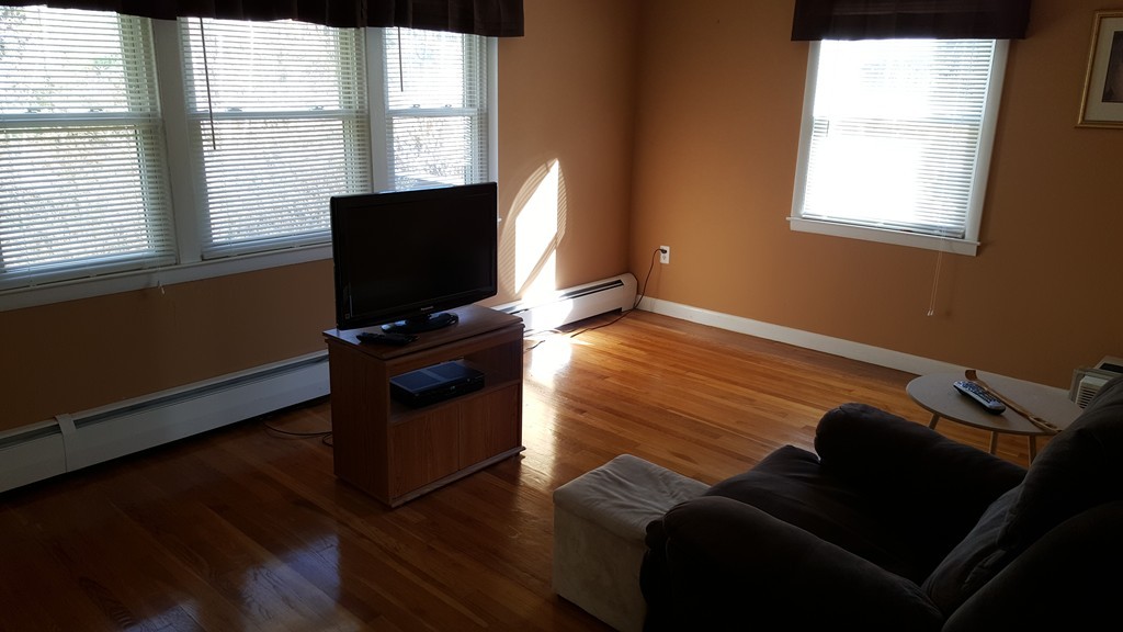 4 Sovereign Heights Sutton, MA 01590 - Photo 13 of 16 a living room with furniture and a flat screen tv