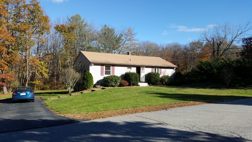 4 Sovereign Heights Sutton, MA 01590 - Photo 2 of 16 a front view of a house with a yard and trees