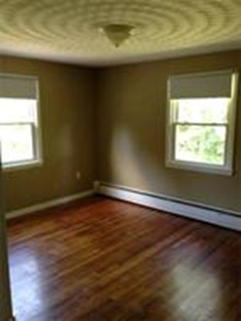 4 Sovereign Heights Sutton, MA 01590 - Photo 6 of 16 a view of an empty room with wooden floor and a window