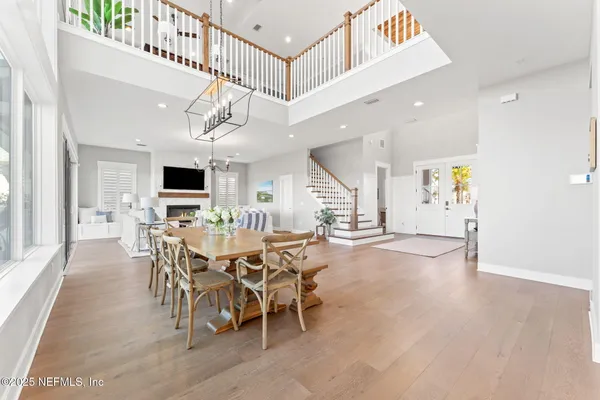 a bedroom with a bed a chair and dresser with wooden floor