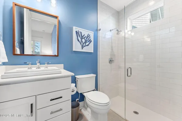 a view of a walk in closet with clothes and shoes