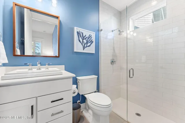 a view of a walk in closet with clothes and shoes