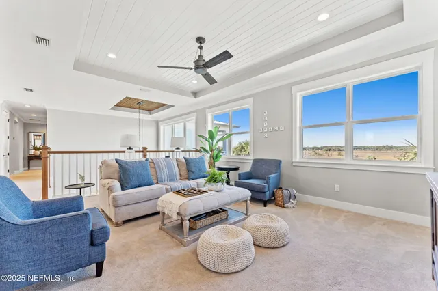 a view of a balcony with wooden floor and outdoor seating