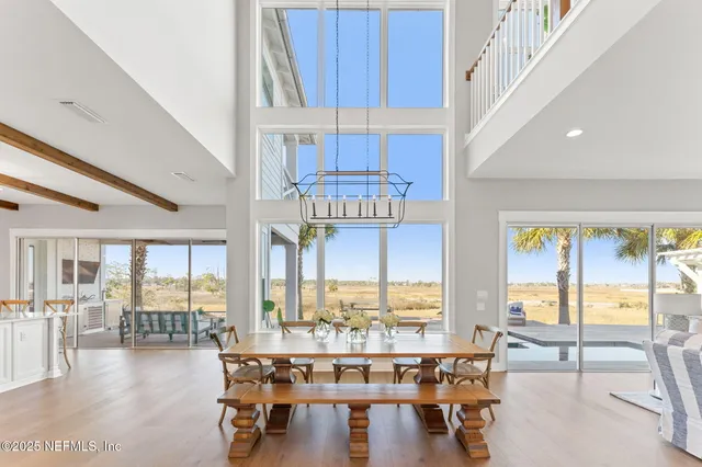 a kitchen with stainless steel appliances kitchen island granite countertop a table chairs and a refrigerator