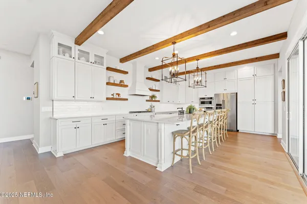 a view of a dining room with furniture and a chandelier