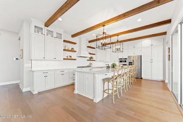 a view of a dining room with furniture and a chandelier