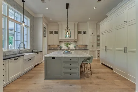 a spacious bathroom with a granite countertop sink a mirror and a bathtub
