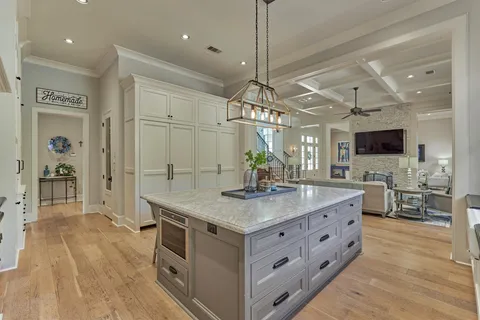 a kitchen with stainless steel appliances granite countertop a stove oven and a wooden floors