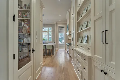 a large white kitchen with stainless steel appliances