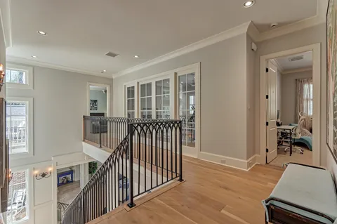a living room with furniture a flat screen tv and a large window
