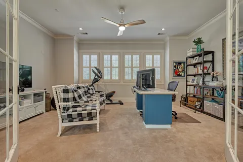 a bedroom with two beds and a large window
