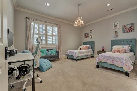 a bedroom with a bed and a chandelier