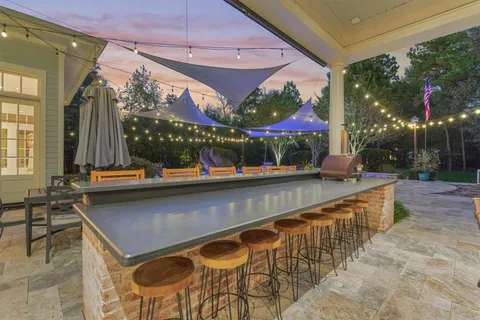 a view of a patio with table and chairs and potted plants