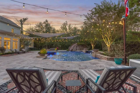 a view of a swimming pool with sitting area