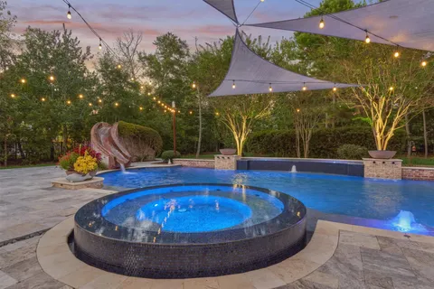 an aerial view of a house with a yard basket ball court and outdoor seating