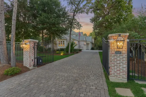 a pathway of a house with a yard and potted plants