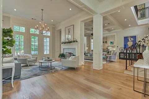 a living room with fireplace furniture and a wooden floor