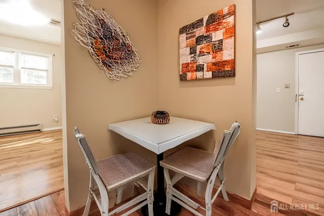 a view of a dining room with furniture and wooden floor