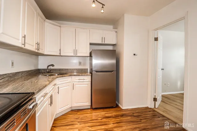 a kitchen with a sink stove and refrigerator