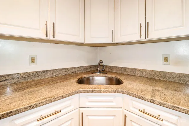a kitchen with a sink and cabinets