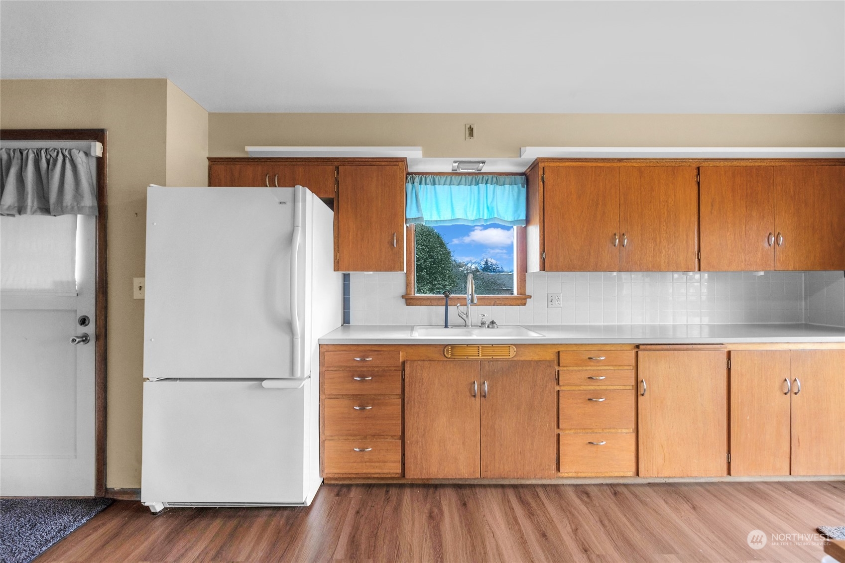 2101 Rockefeller Avenue Everett, WA 98201 - Photo 11 of 26 a white refrigerator freezer sitting inside of a kitchen